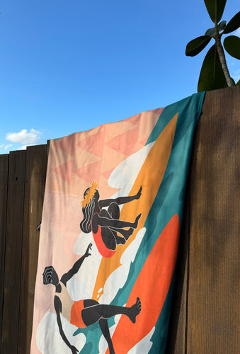 surfer towel 'slide with me' hanging on a fence close up