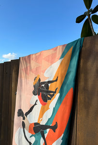 surfer towel 'slide with me' hanging on a fence close up