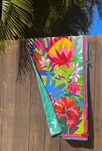 Suzanne Jennerich x Surfer Towel on a fence with palm fronds in the background