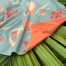 Floral-patterned fabric draped over green leaves