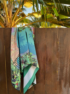 close up of the poolside towel (by artist Christie Shinn) hanging over a fence to dry.