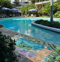 wayfinder waikiki with towel design called poolside.  The towel is laying in front of the Wayfinder Waikiki pool.